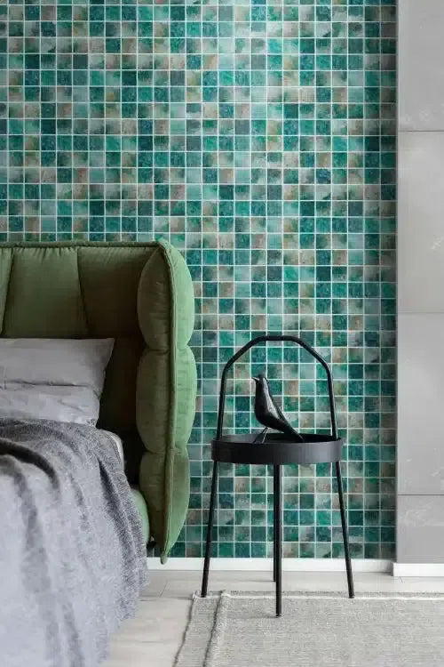 Mint green upholstered headboard with gray bedding.